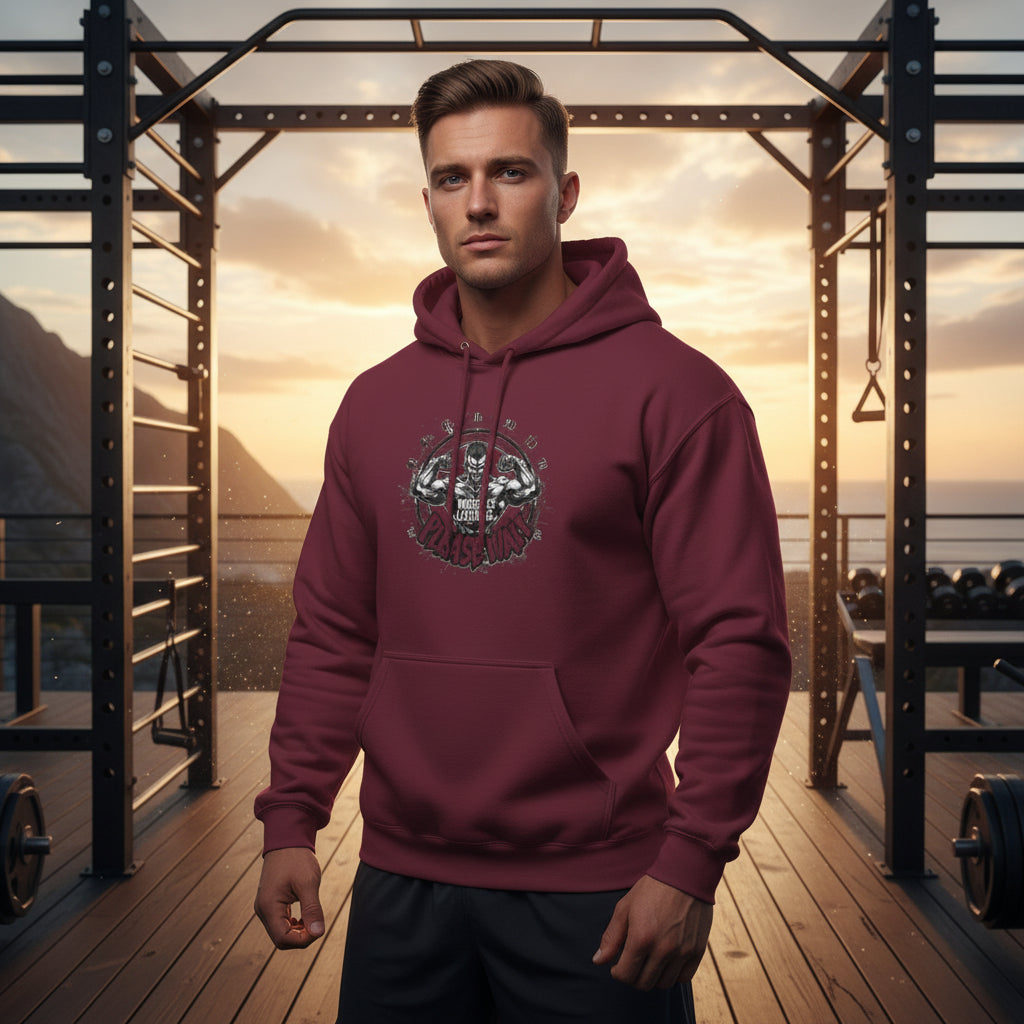 Man wearing a maroon hoodie with a graphic design that says Muscles Loading Please Wait in an outdoor setting with mountains and a sunset.