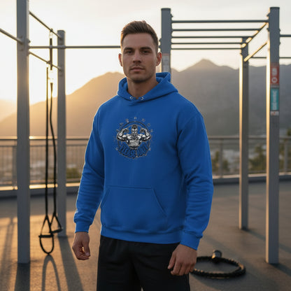 Man wearing a blue hoodie with a graphic design that says Muscles Loading Please Wait outdoors during sunset.