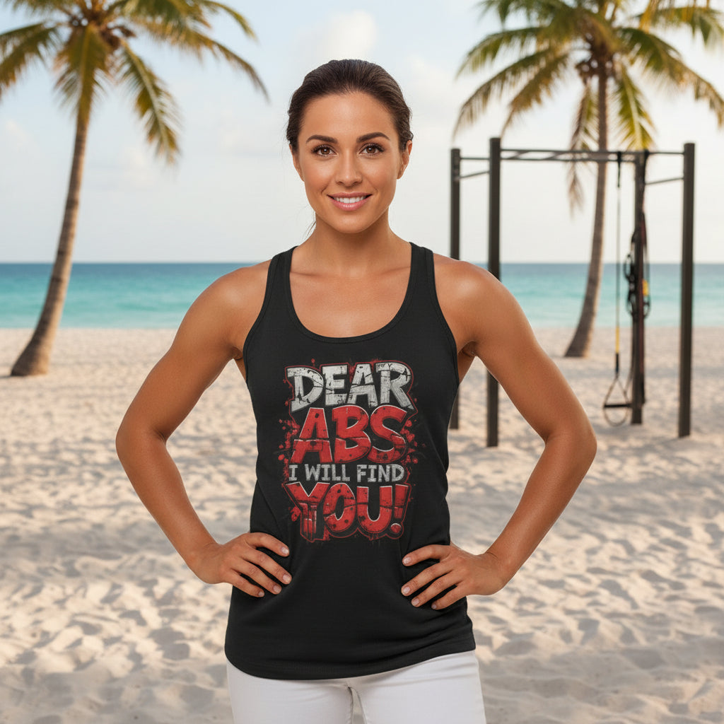 Woman wearing a black tank top with red and white text in an outdoor beach setting.