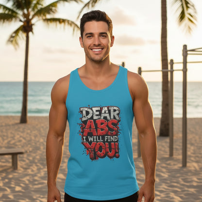 Man wearing a light blue tank top that says Dear Abs I Will Find You! in an outdoor beach setting.
