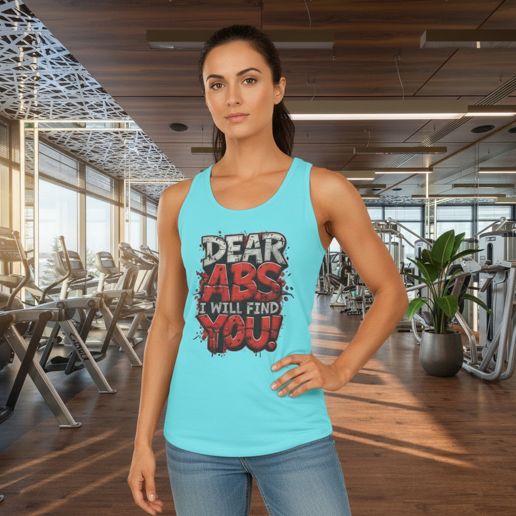 Woman wearing a light blue tank top with a humorous fitness slogan that says Dear Abs I Will Find You! in a gym setting.