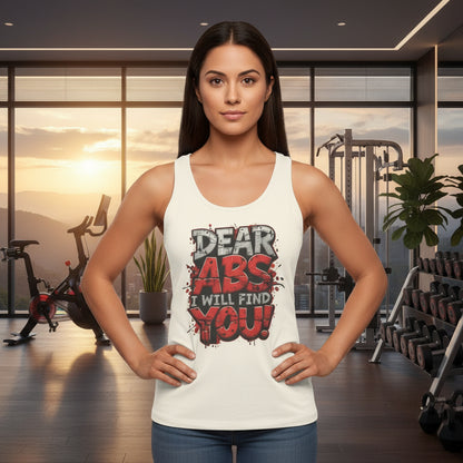 Woman wearing a white tank top with fitness-themed text that says Dear Abs I Will Find You! in a scenic home gym setting.
