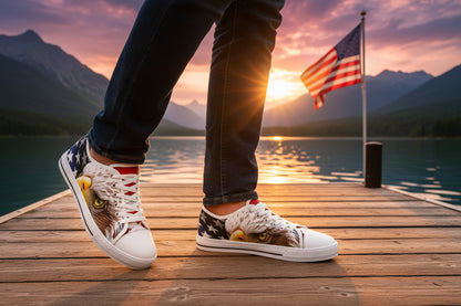 A person wearing white sneakers with an American flag bald eagle design on a dock during sunset.